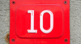 A red metal sign with the number ten in white.