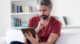 Middle aged man using a tablet.