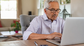 Senior man using a laptop.