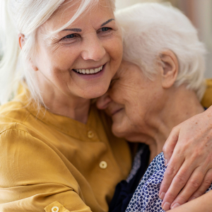 Woman hugging her senior mother