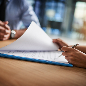 Signing a document during a meeting with a professional