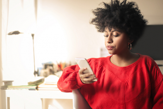 Young woman looking at her phone.