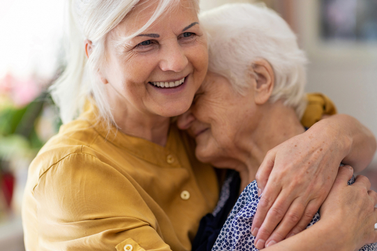 Woman hugging her senior mother