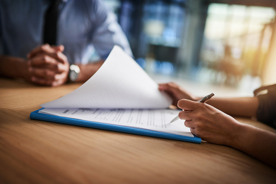 Signing a document during a meeting with a professional