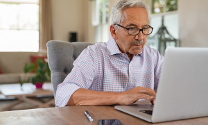 Senior man using a laptop.