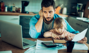 Worried father reviewing family bills